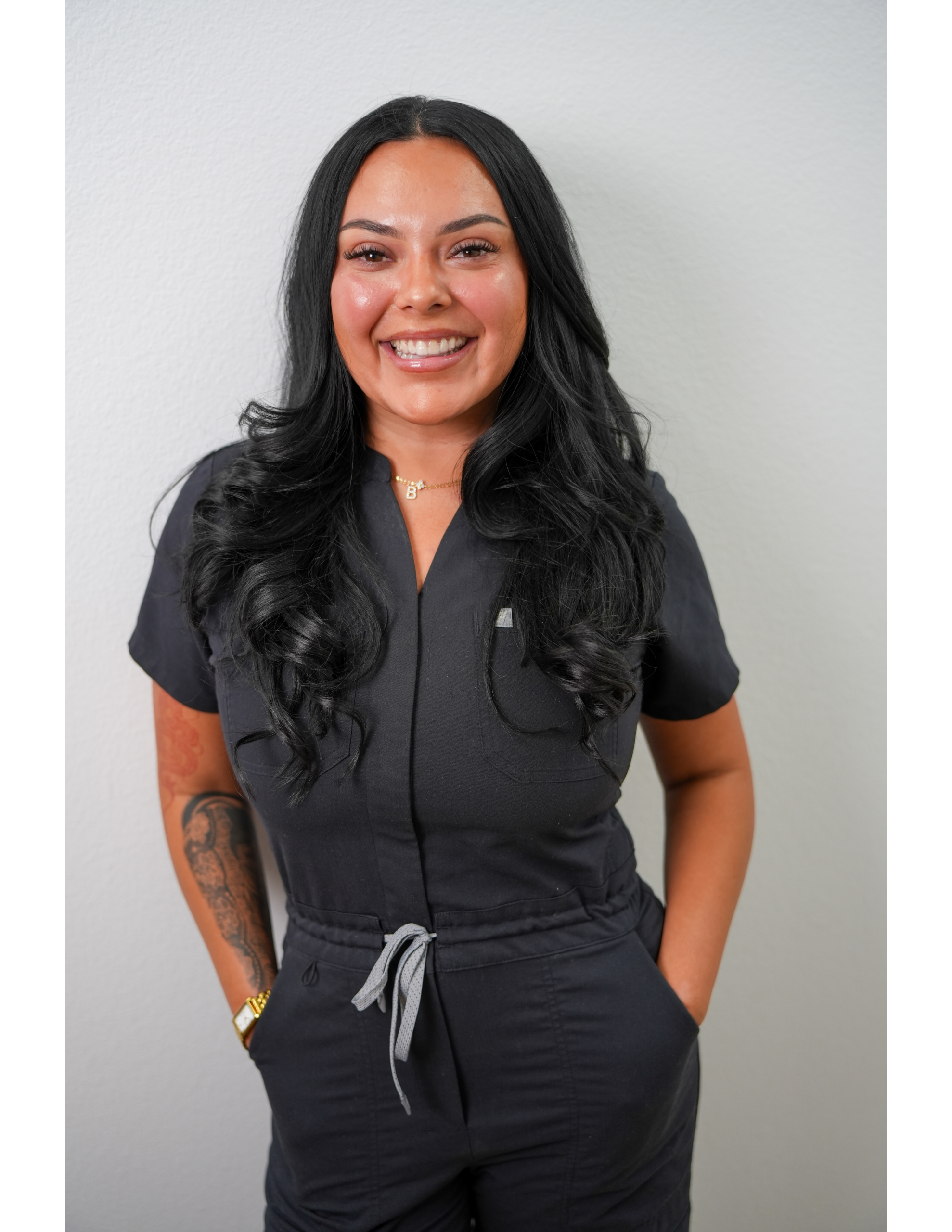 Smiling woman in black medical scrubs