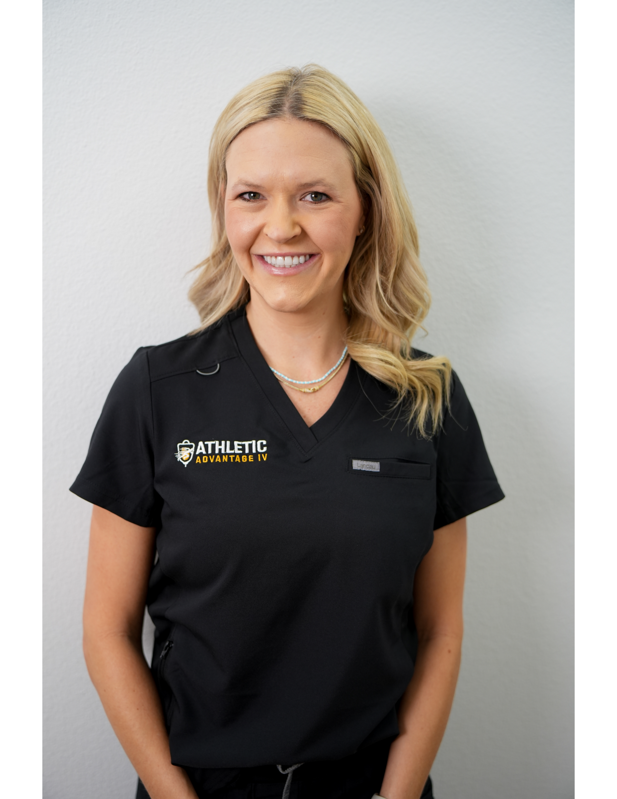 Smiling healthcare worker wearing black scrubs