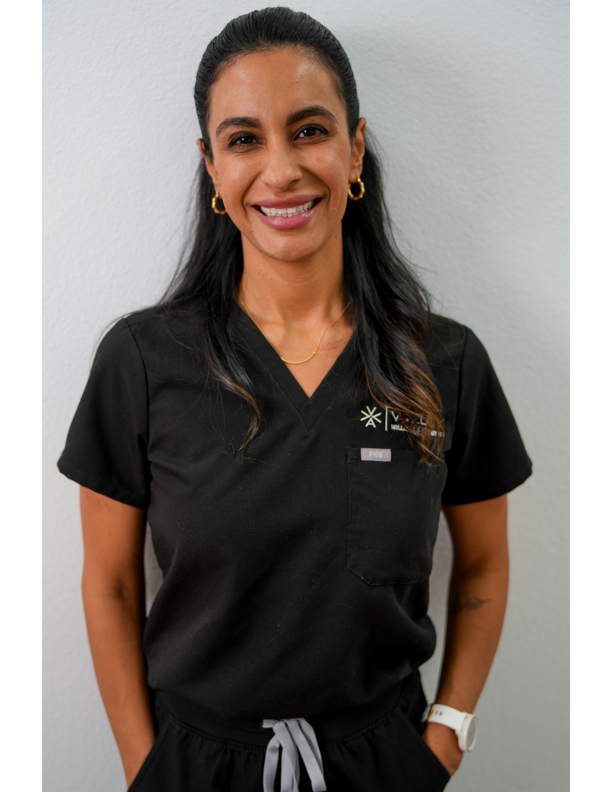 Smiling healthcare worker in black scrubs