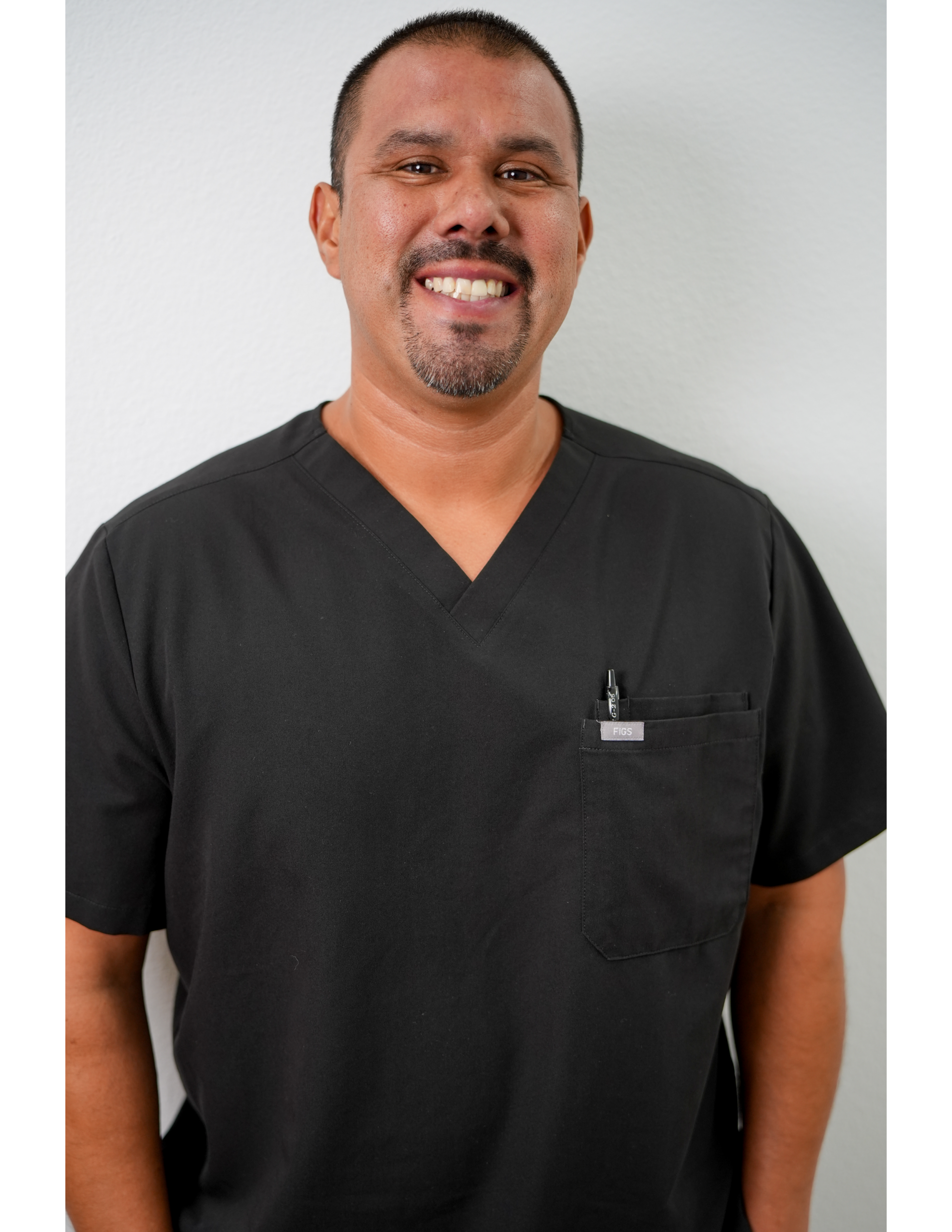 Smiling healthcare worker in black scrubs